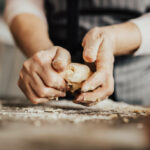Close-up of woman's hands kneading dough